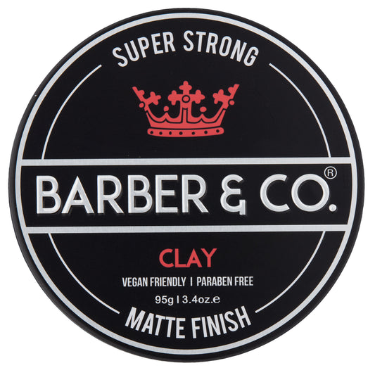 A product image featuring a container of BARBER & CO. hair clay with the label 'SUPER STRONG' at the top, indicating a matte finish and vegan friendly attributes.